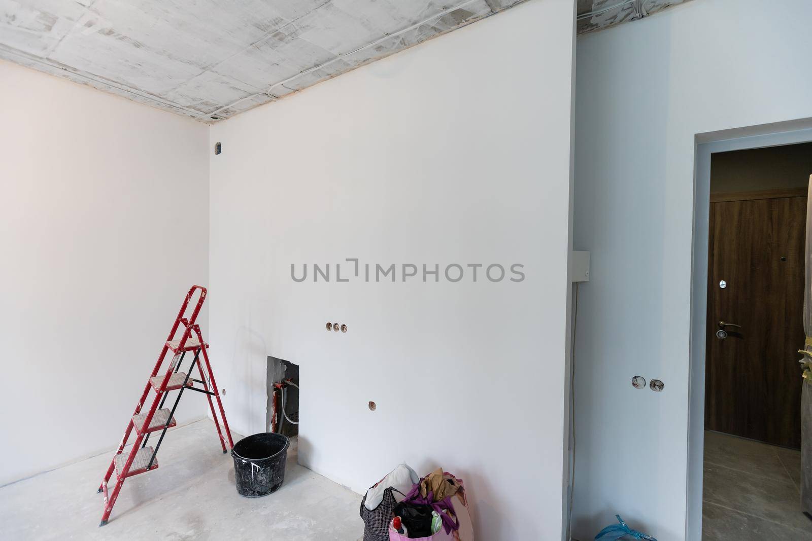 Home renovation in room full of painting tools