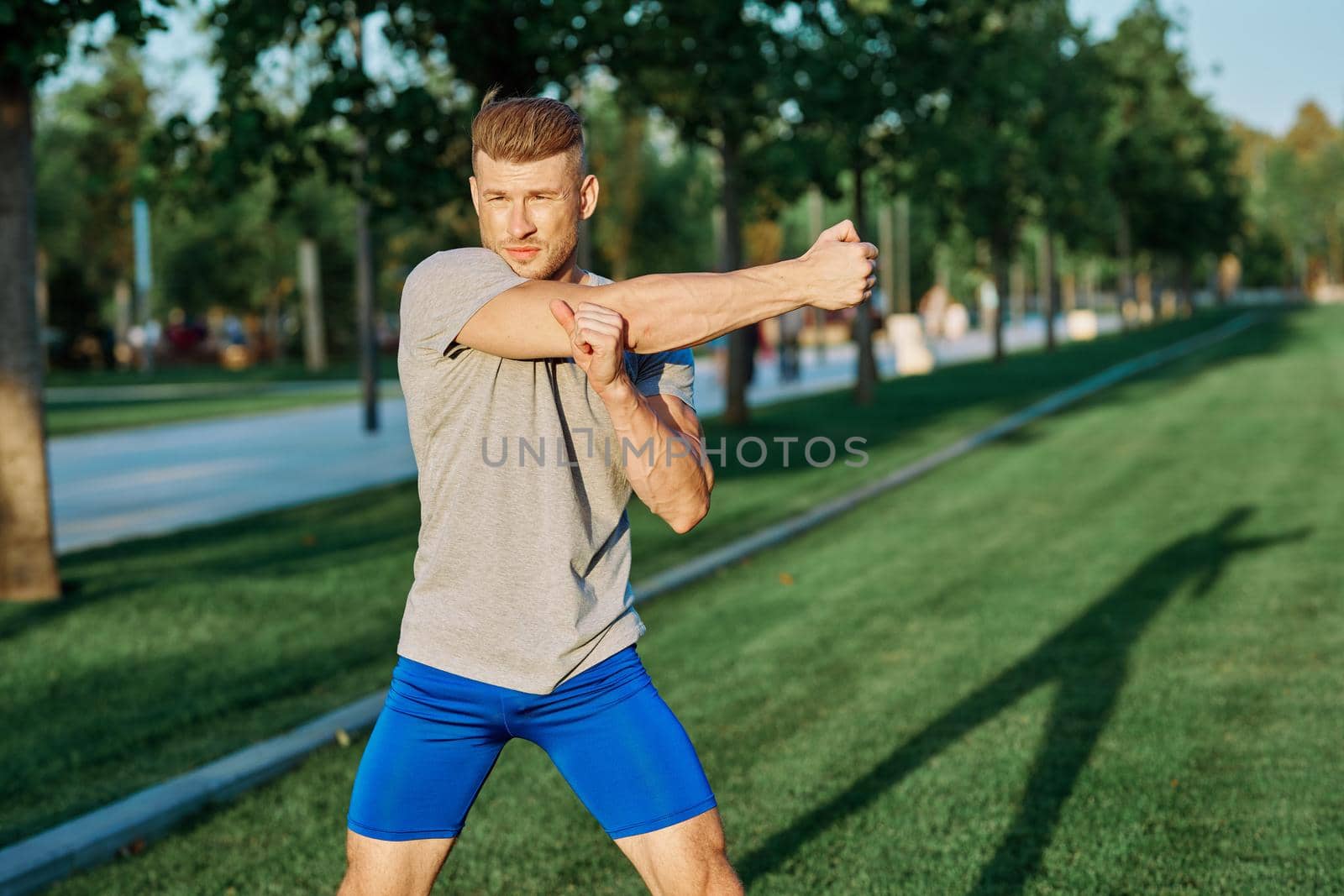athletic man in the park workout jogging exercise summer. High quality photo