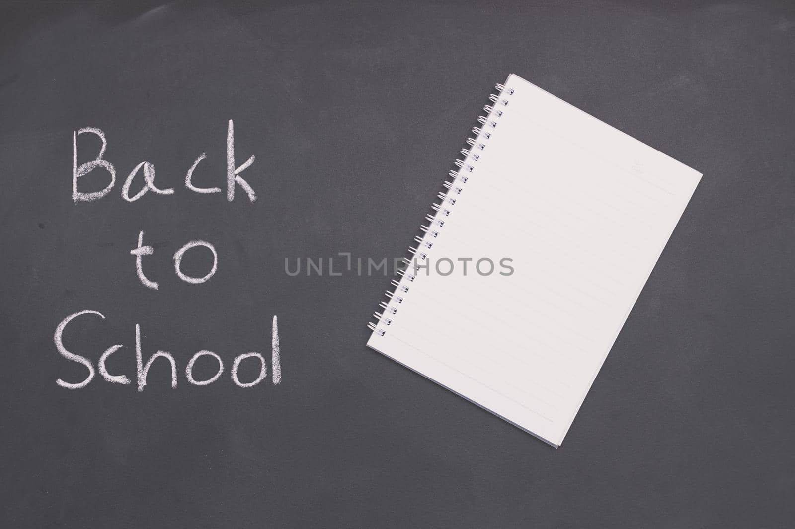 Back to school and education concept  book on blackboard