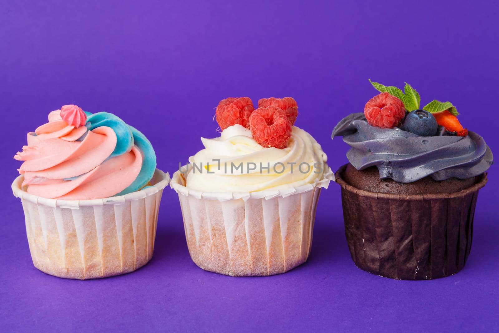 Beautiful cupcake against saturated dark purple background