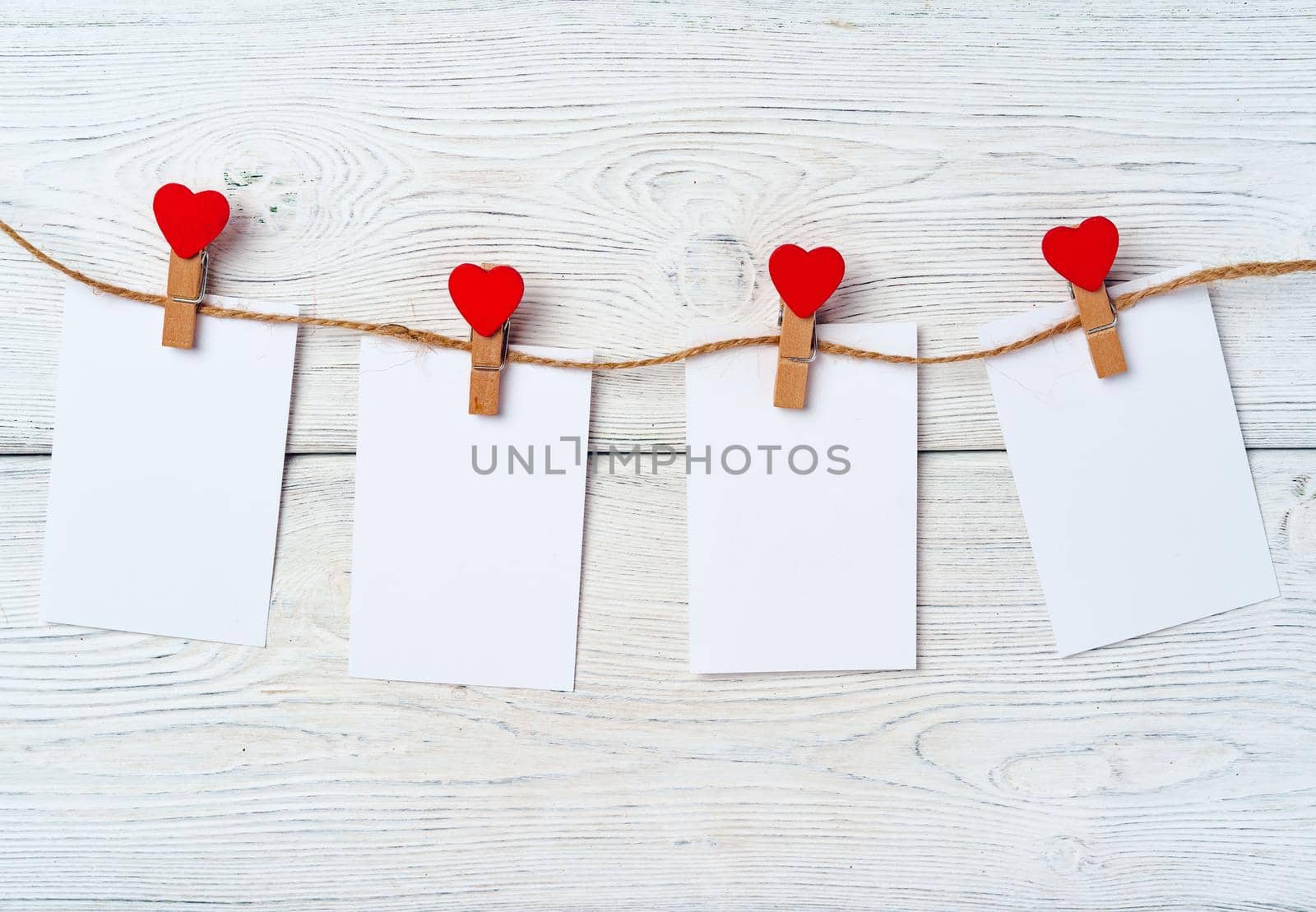 Heart clothespins on rope. Creative background with copy space, top view