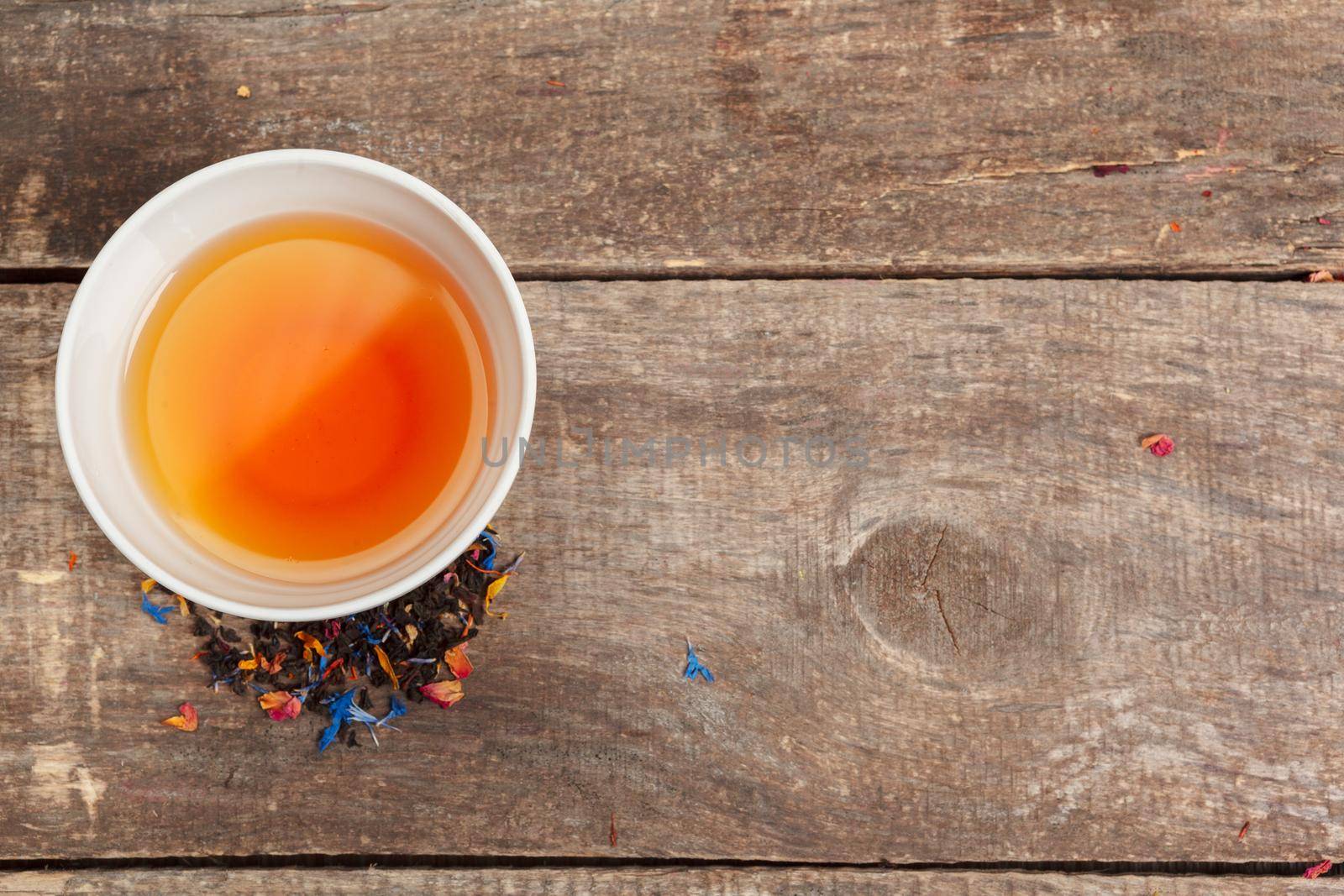 Collection of different teas in cups with tea leaves