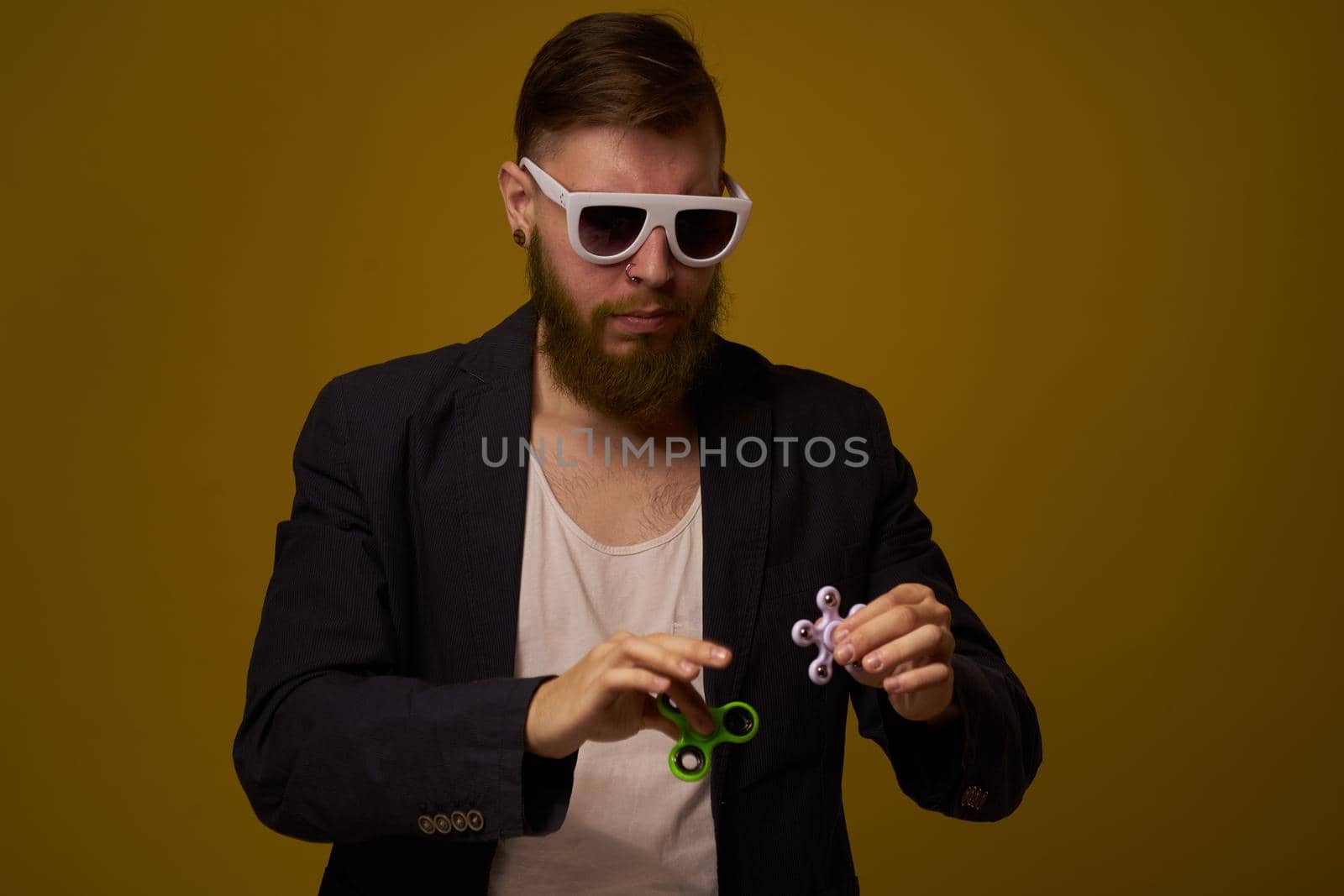 man wearing sunglasses spinner in hands fashion posing black jacket. High quality photo