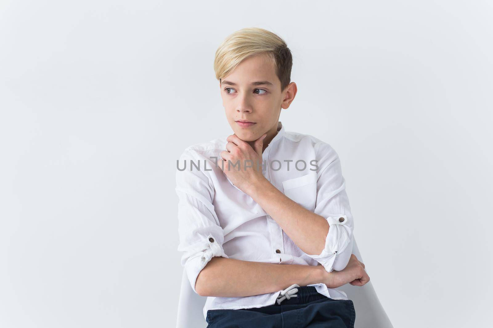Teenage depression and puberty concept - Sad teenager portrait close up on white.