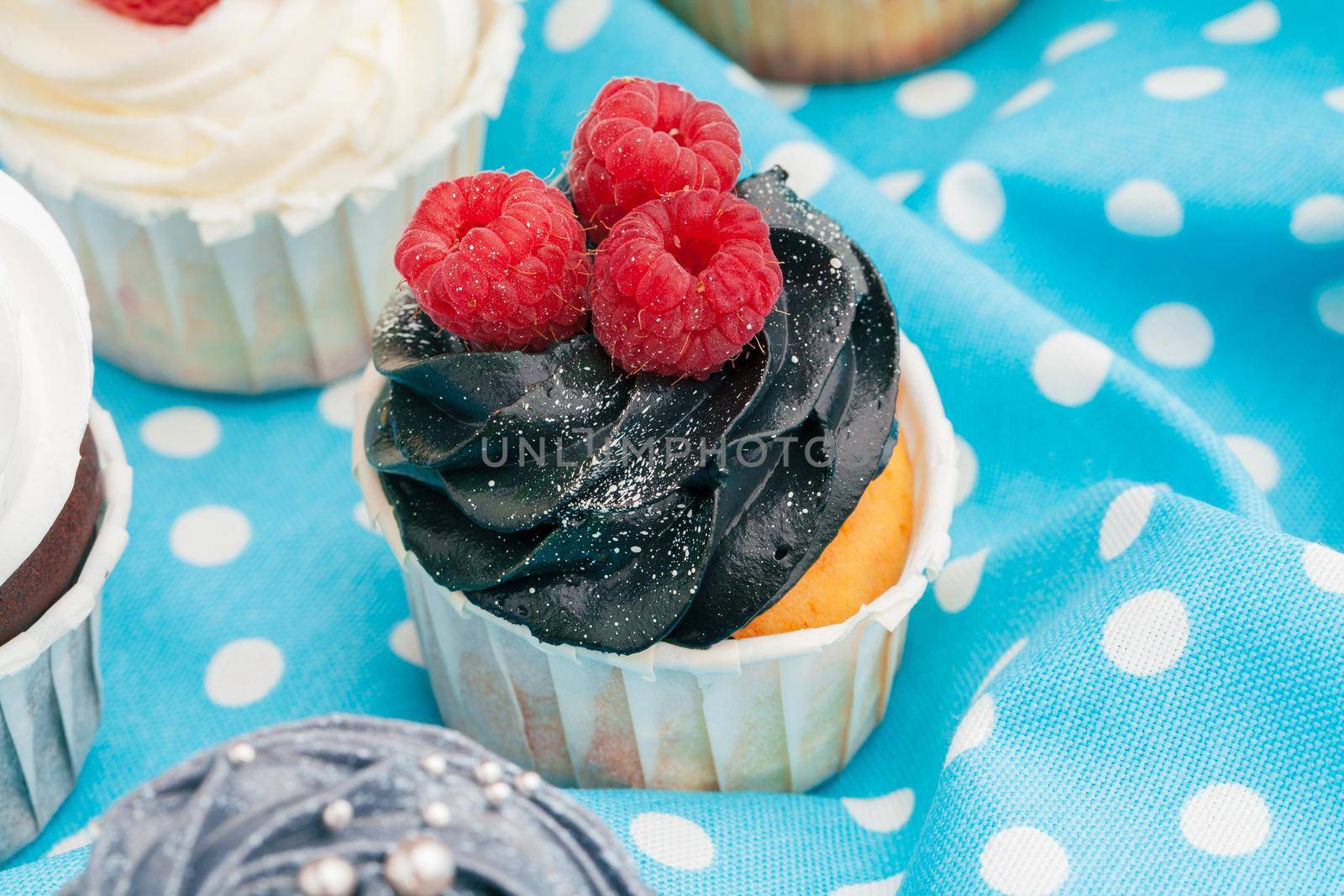 Cupcakes decorated with sprinkles and frosting - close up