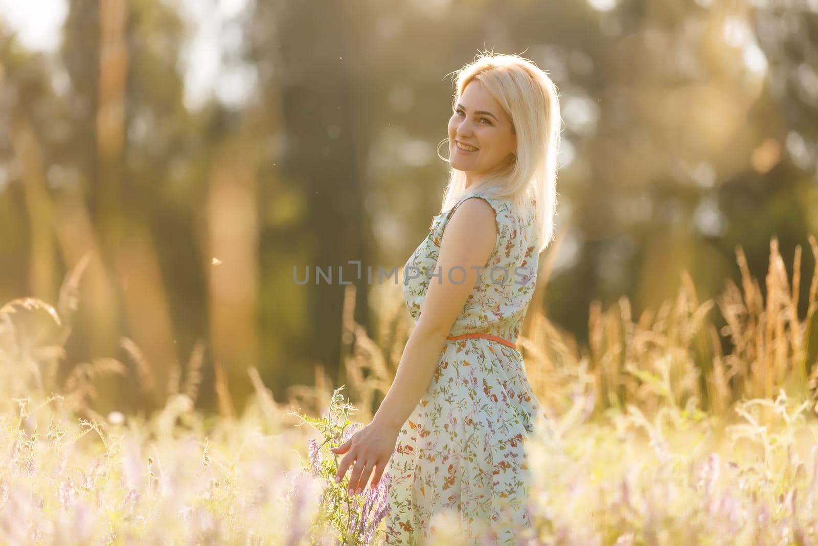 Close up of a woman's hand touching golden grass