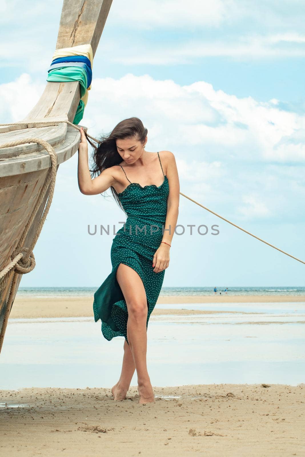 the photo of a charming brunette long-haired woman on the ocean. Fashion and glam concept. Copy space