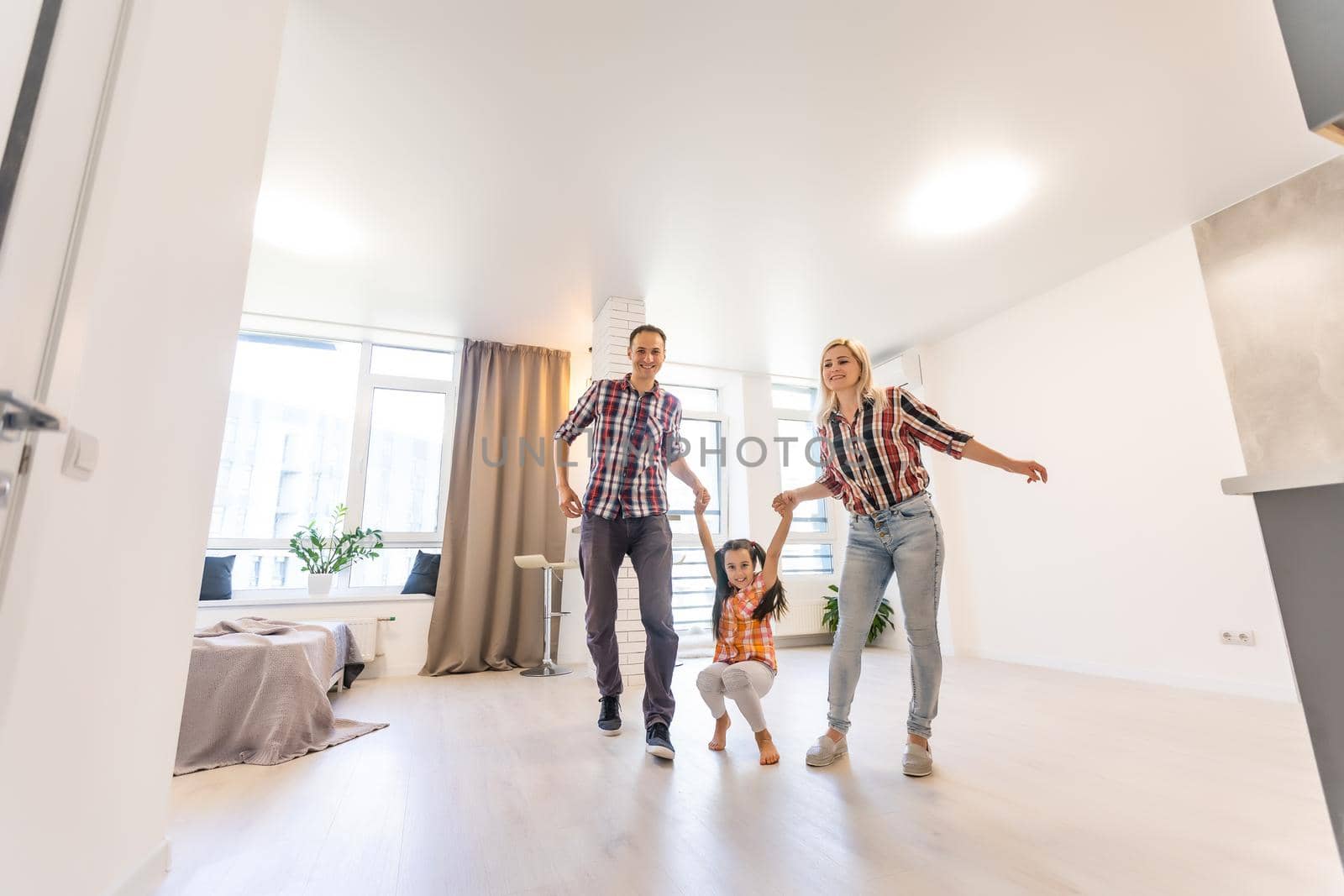 Concept family: Happy young family in the new apartment dream and plan interior