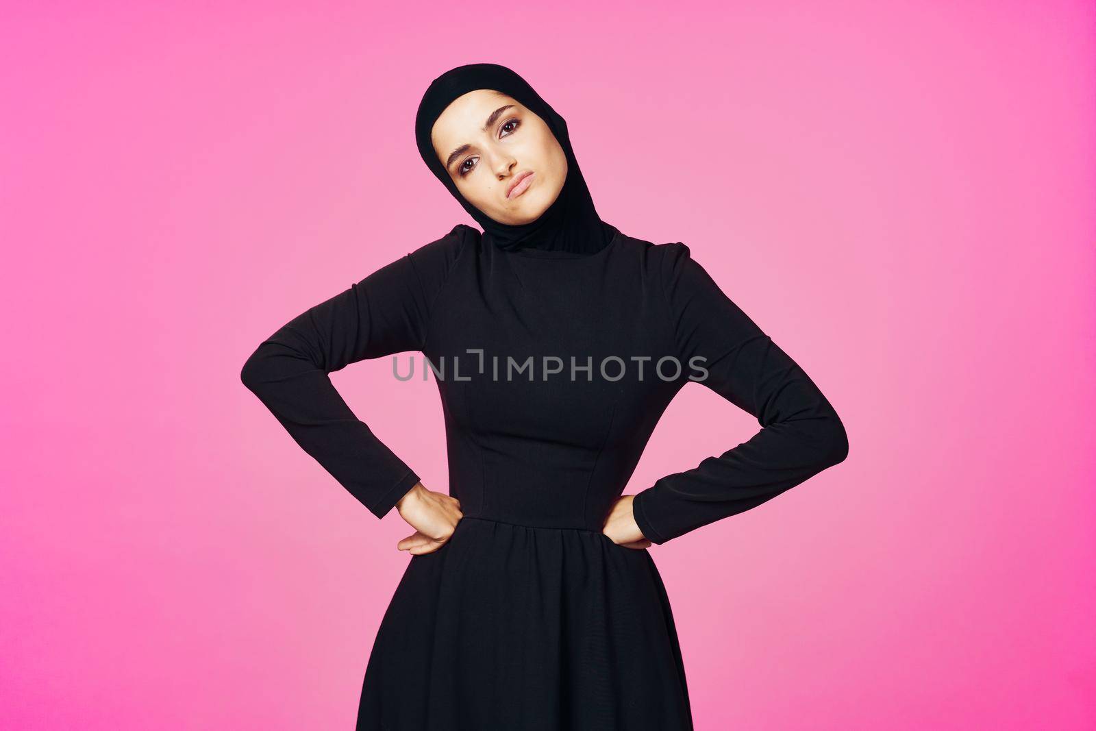 muslim woman in black hijab posing hand gesture model. High quality photo