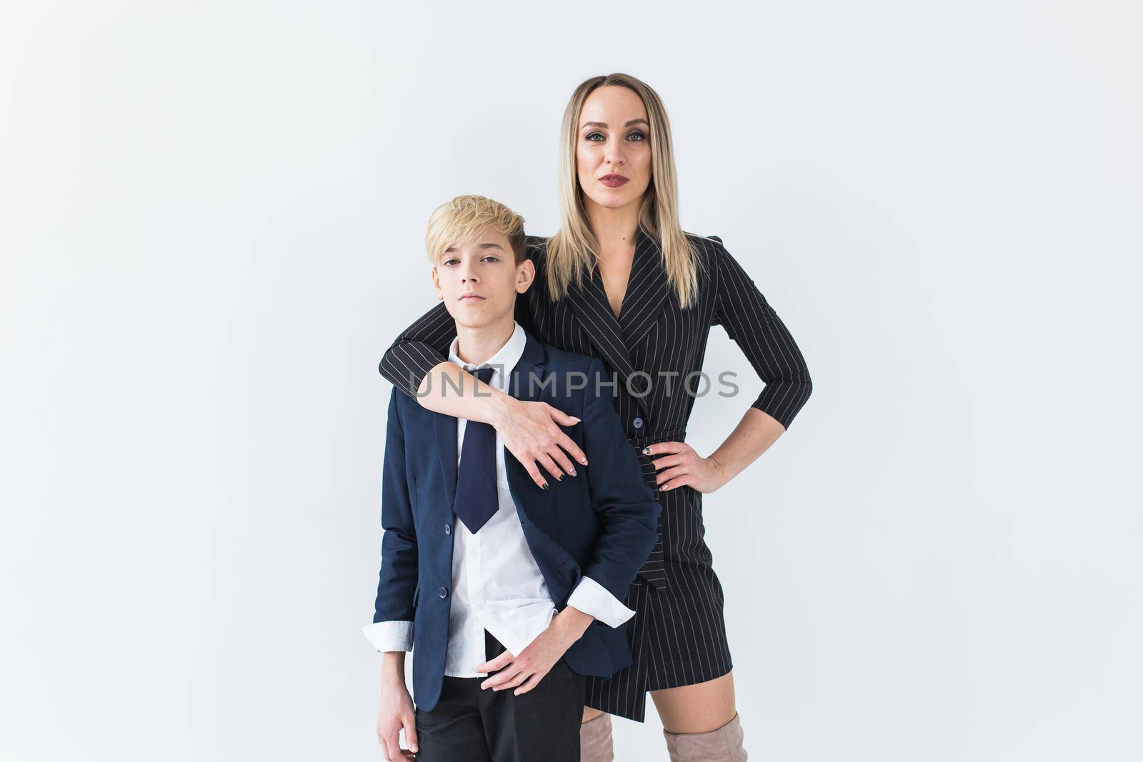Parenting, family and single parent concept - A happy mother and teen son smiling on white background. by Satura86