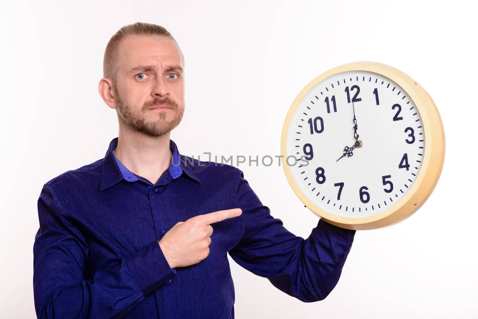 Strict man holding a large wall clock and points a finger at them by zartarn