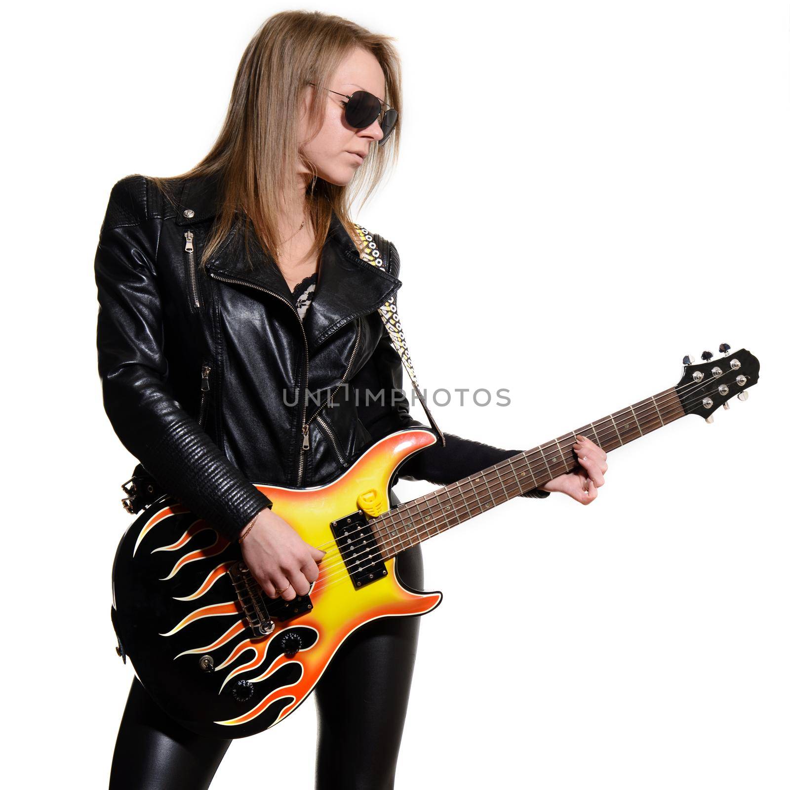 Sexy blonde girl in sunglasses black leather jacket playing black electric guitar on white background