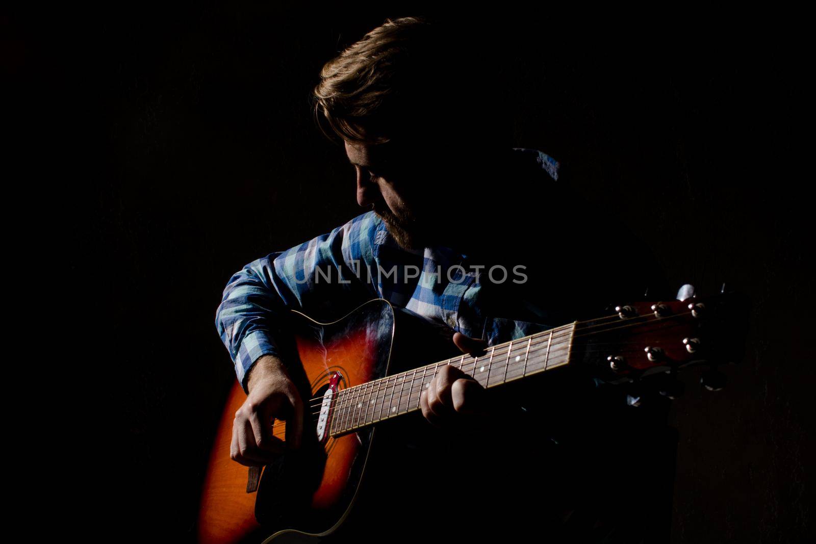 High contrast portrait of bearded man in plaid shirt playing acoustic guitar by zartarn