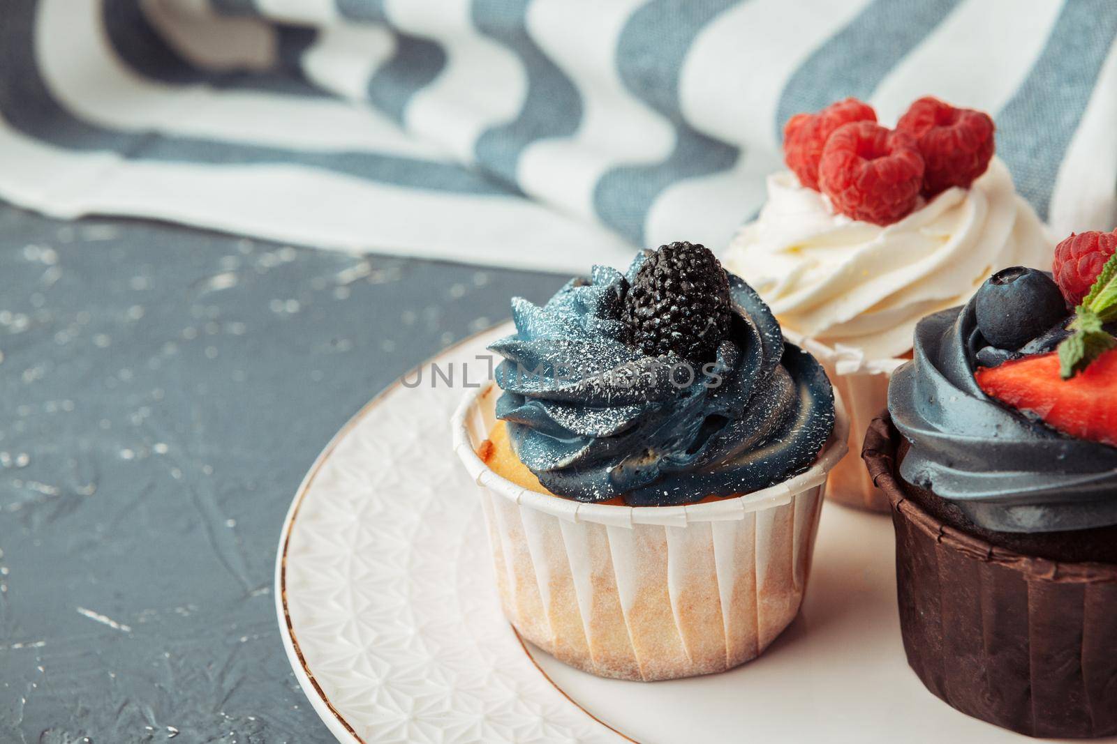 Group of cupcakes on dark background selective focus