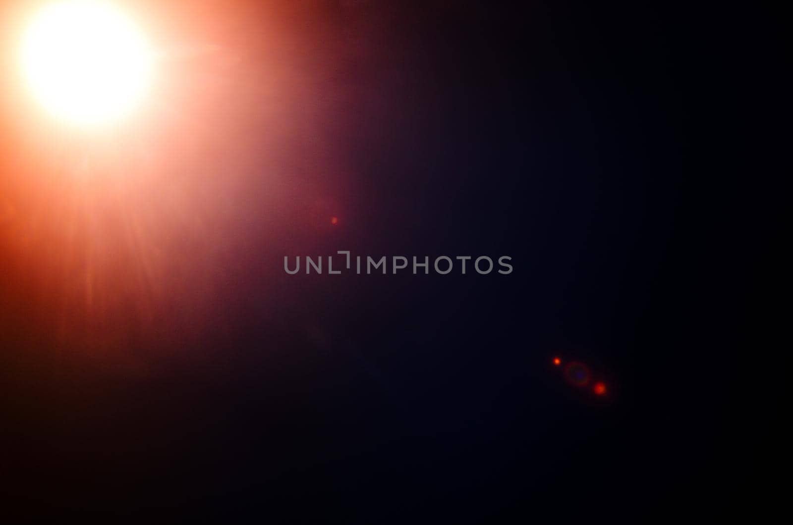 Abstract Natural Sun flare or Far star on the black background - image