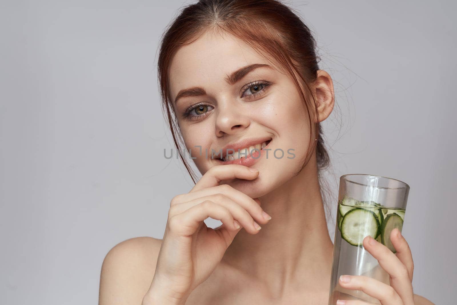 woman with cucumber drink health vitamins close-up. High quality photo