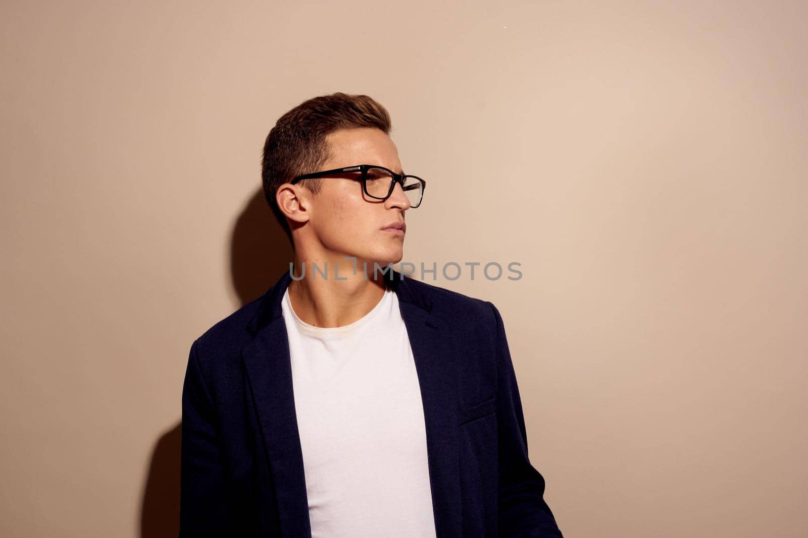 businessmen fashion posing with glasses beige background. High quality photo