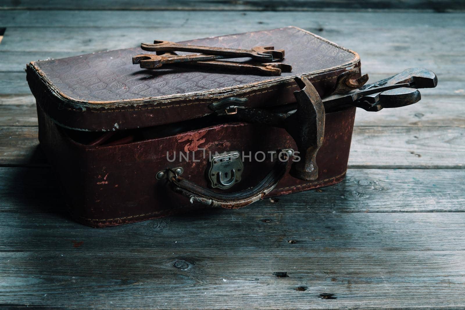 Working tools in vintage case on a wooden table