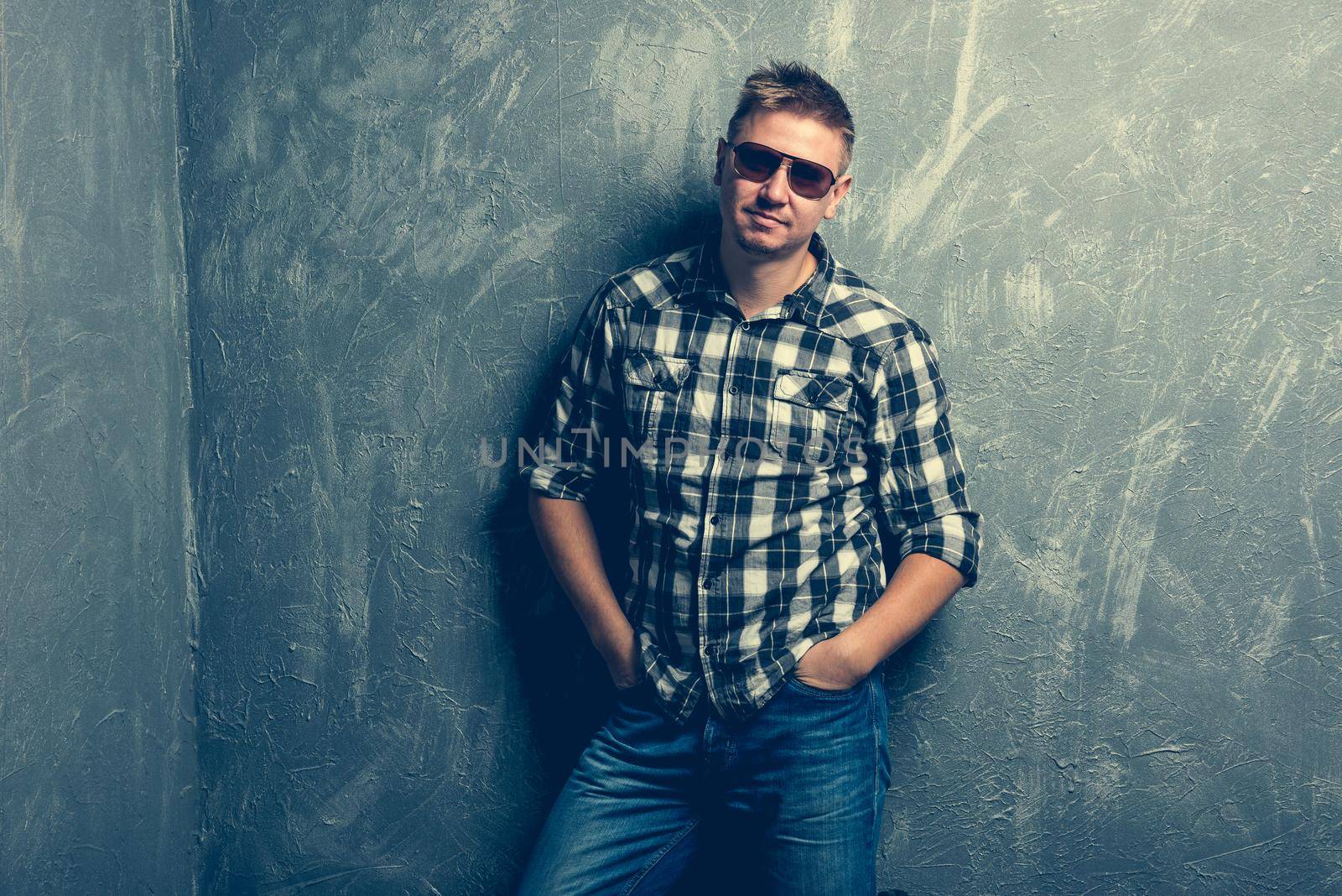 portrait of the man in sunglasses and plaid shirt