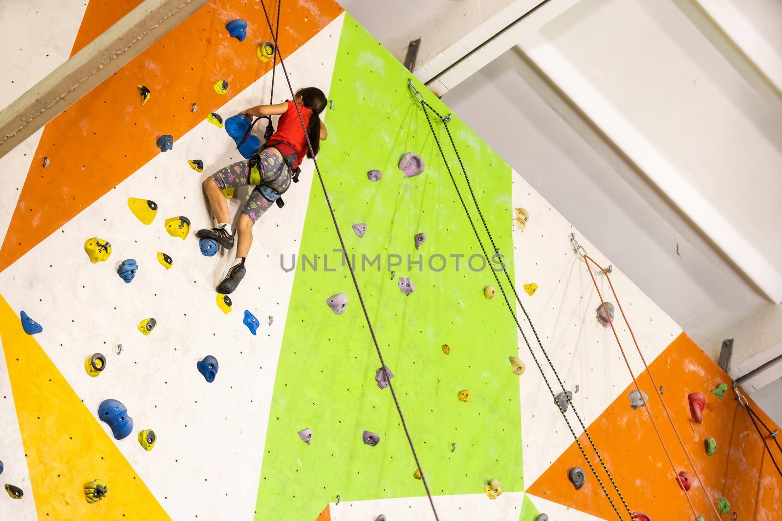 Little Girl Climbing Rock Wall