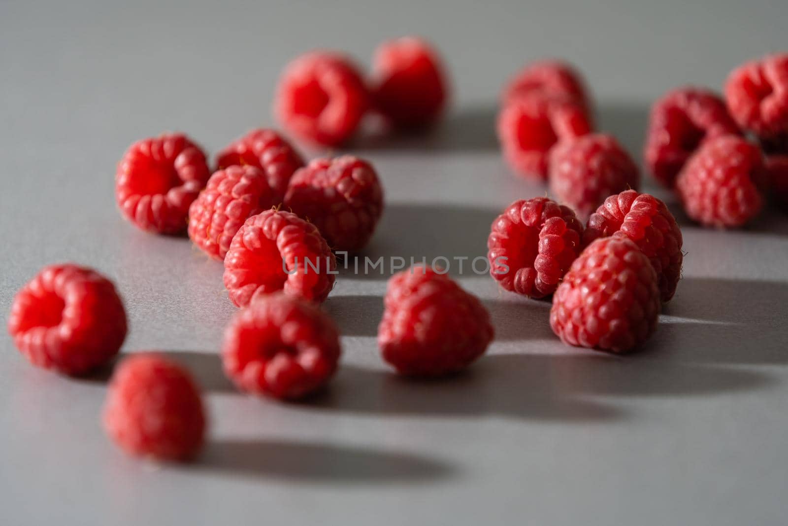 red Raspberry fruit on gray background chocolate