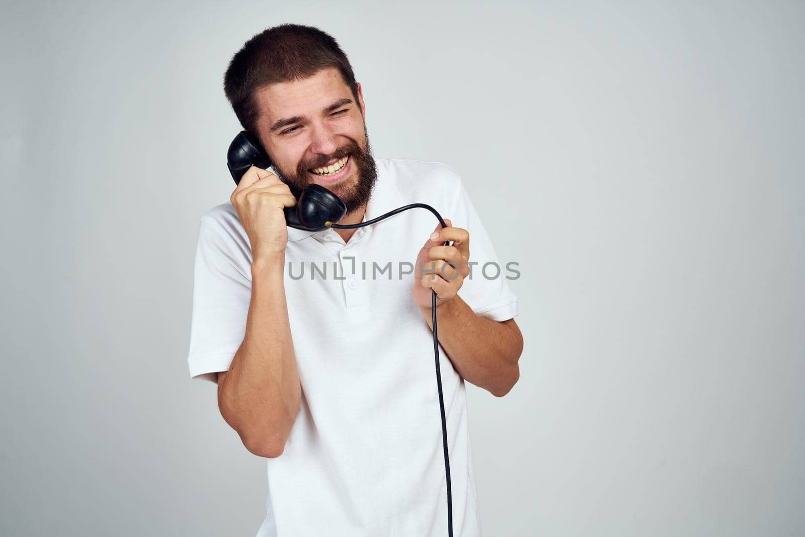 Cheerful man emotions talking on the phone retro style. High quality photo