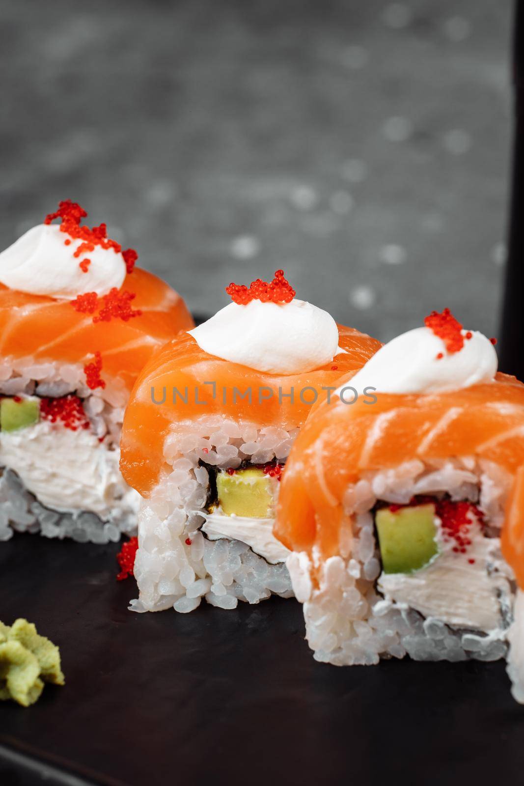 Philadelphia roll sushi with salmon, smoked eel, cucumber, avocado, cream cheese, red caviar. Sushi menu. Japanese food by UcheaD