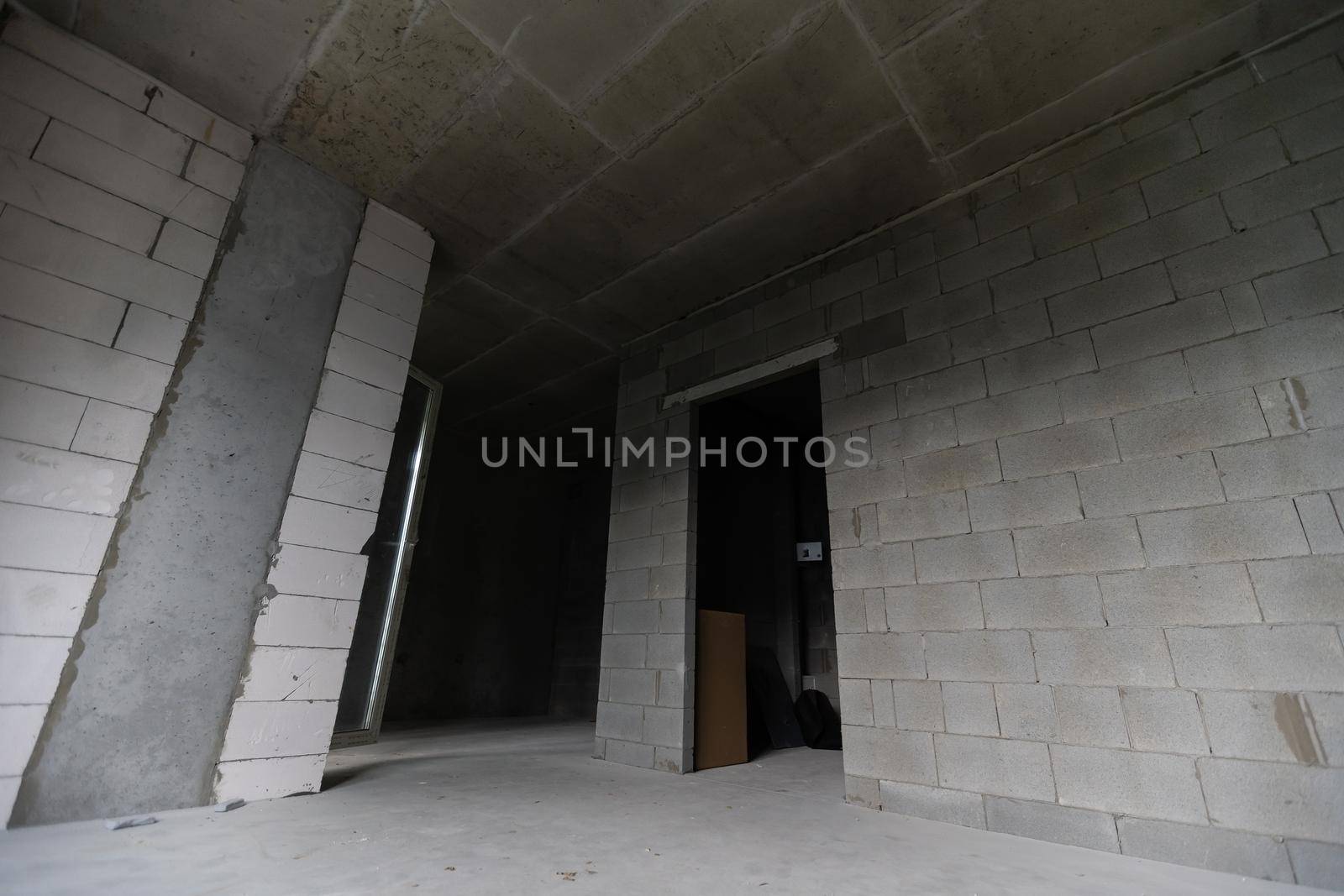 Small apartment without repair in a new building. A room in an unfinished house. Walls of foam block and concrete floor in a tiny apartment.