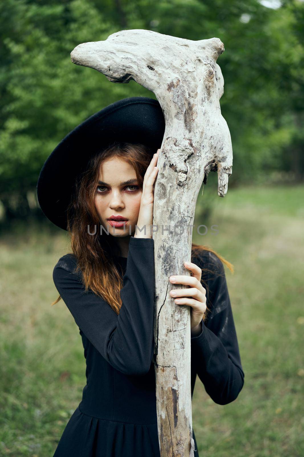 woman in witch costume halloween forest staff gothic. High quality photo