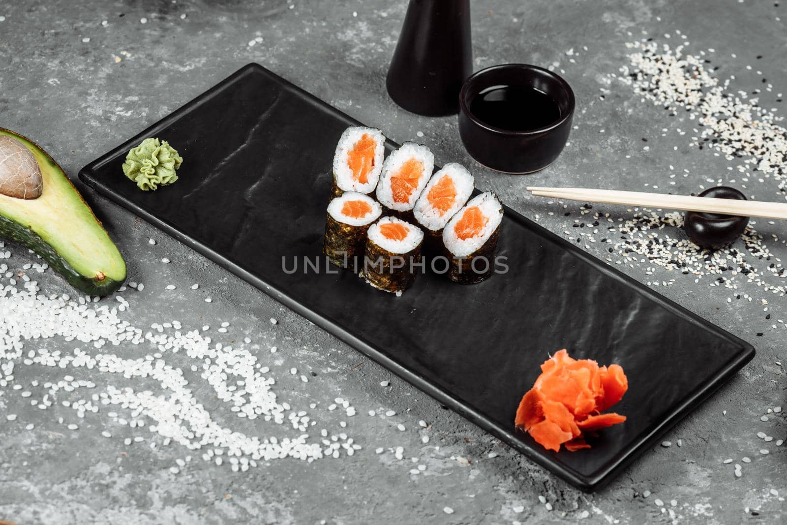 Simple maki with fresh salmon. Sushi on a gray background by UcheaD