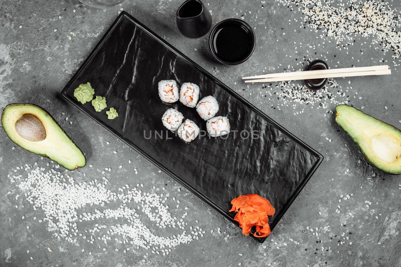 Simple maki with shrimp. Sushi on a gray background.