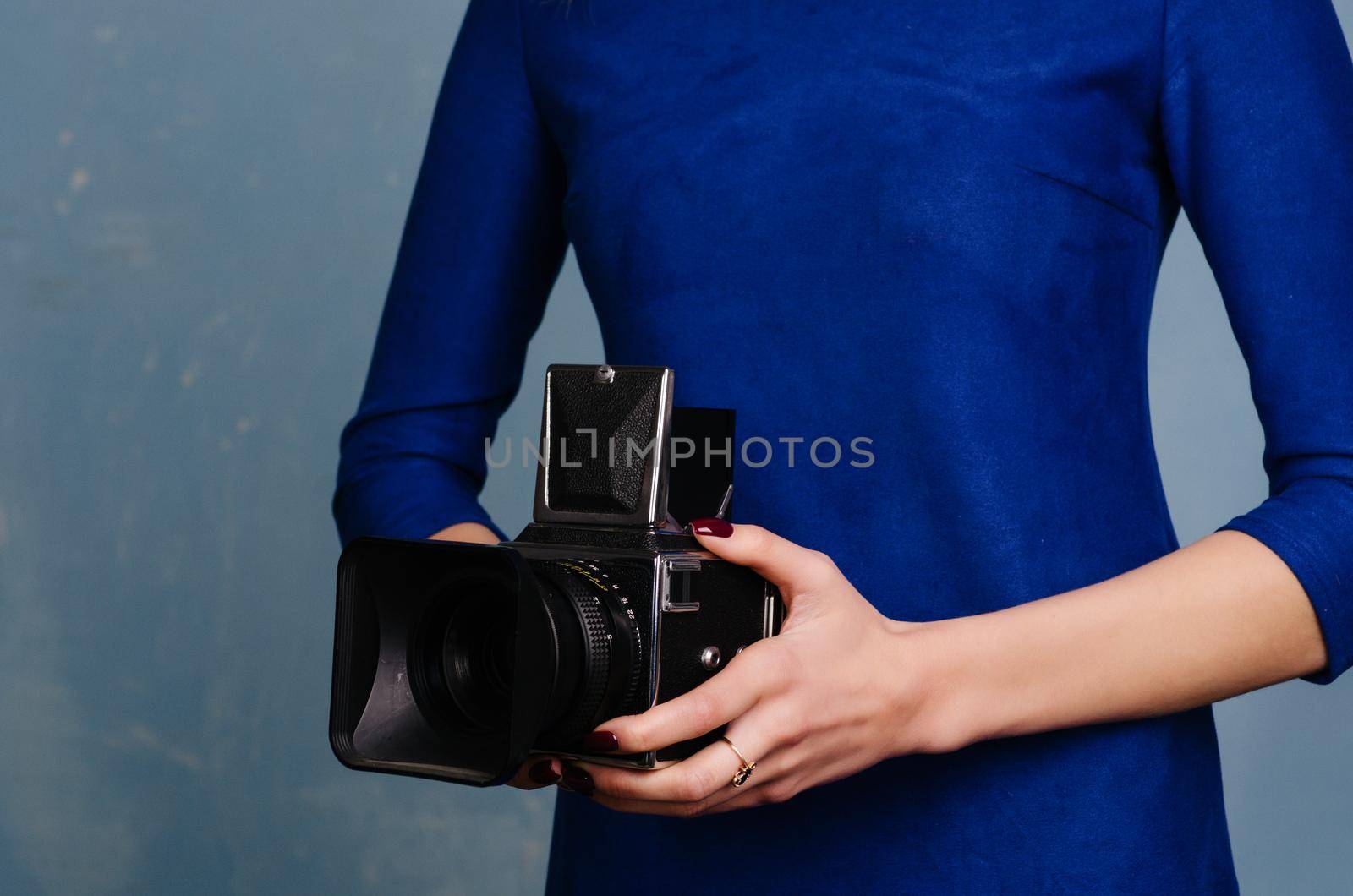 Girl in vintage blue dress holding old medium format camera. by zartarn