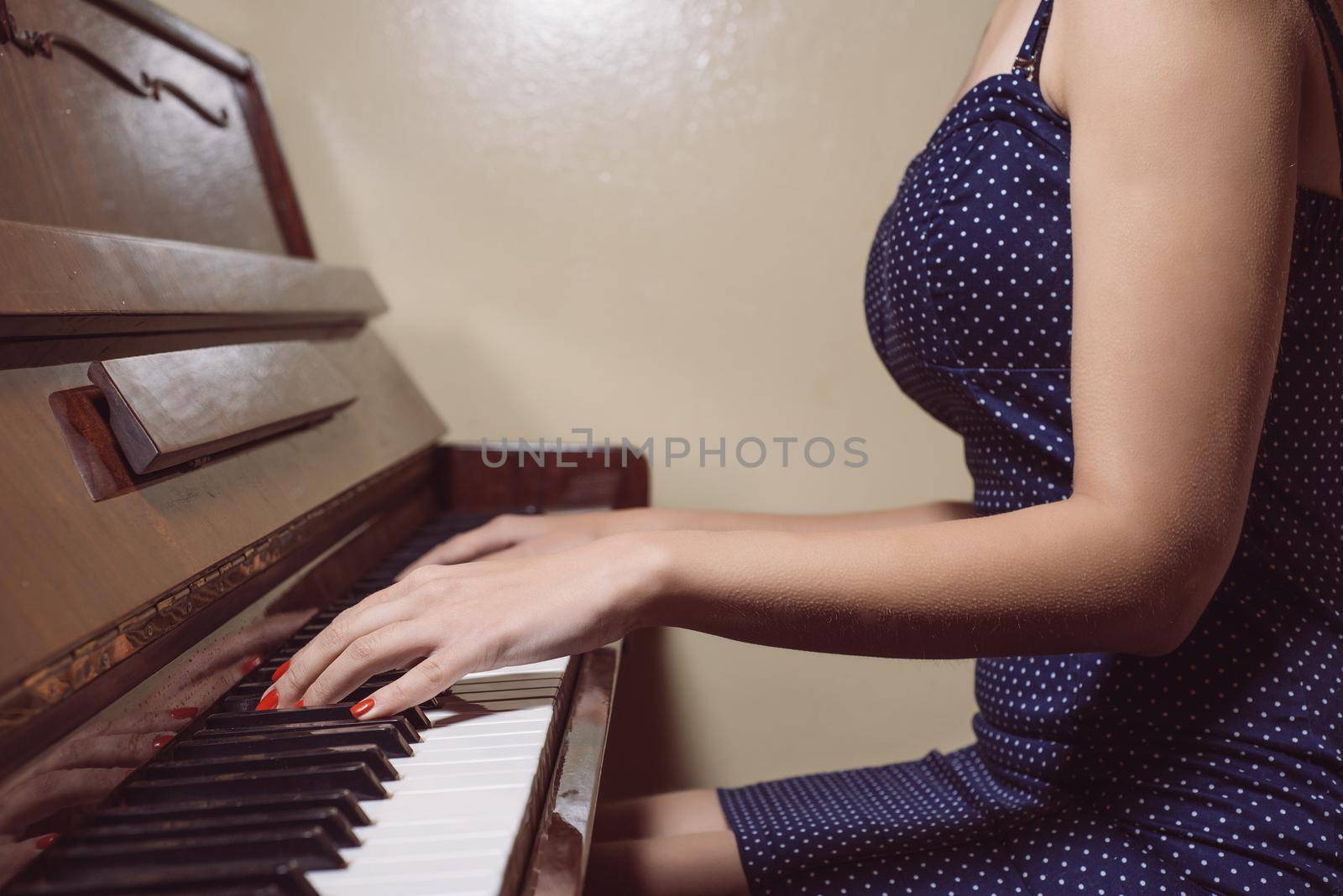 detail of woman hands playing the piano.