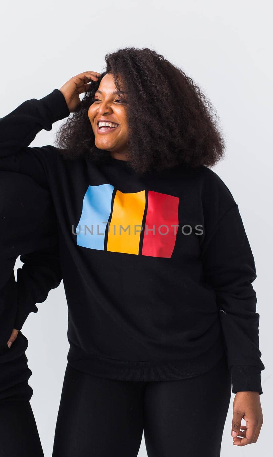 Young beautiful african american girl with an afro hairstyle. Portrait on white background. Girl looking at camera