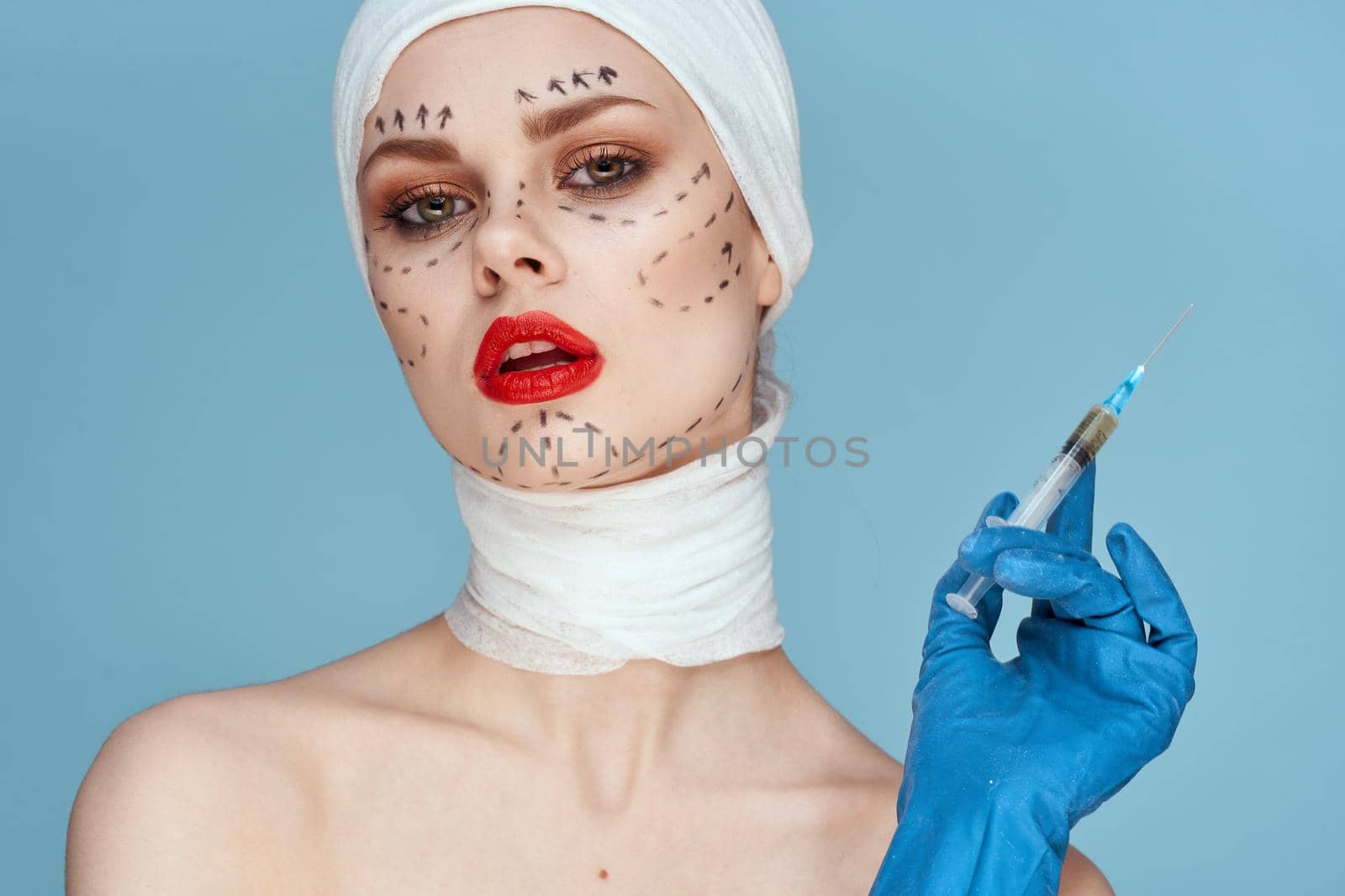 female patient in blue gloves syringe in hands contour on the face lifting close-up. High quality photo