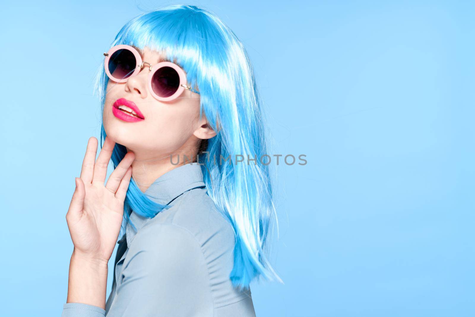 cheerful woman wearing sunglasses blue wig glamor model. High quality photo