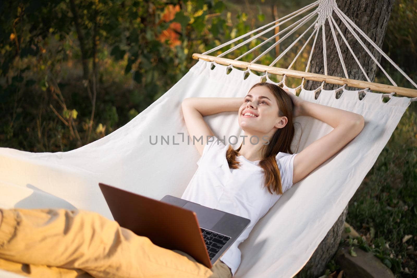 woman lies in the corner with laptop vacation nature technology by Vichizh