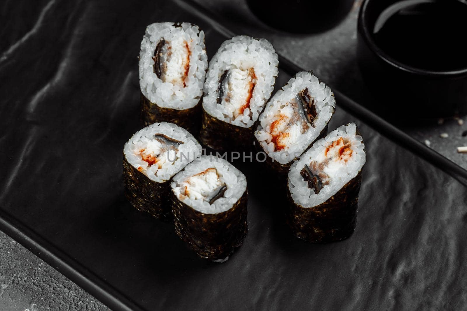 Simple maki with tuna. Sushi on a gray background.