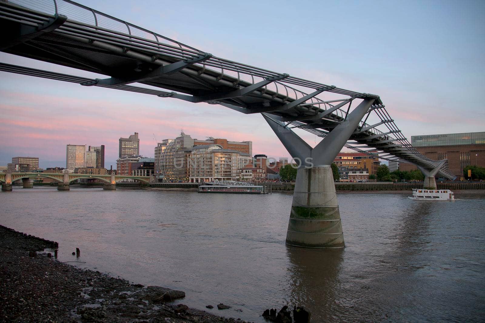 The River Thames and the Millennium Bridge at dusk London UK