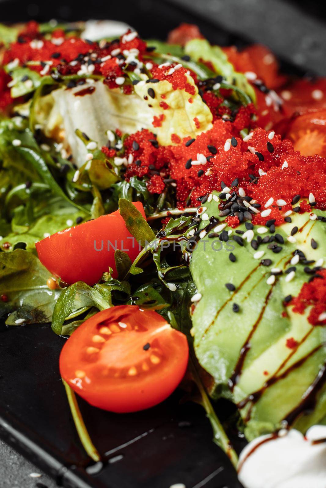 Salmon salad gravlax. Smoked salmon salad, with mixed greens cherry tomatoes avocado black olives carrots sprouts cucumber and lime. Delicious healthy eating.