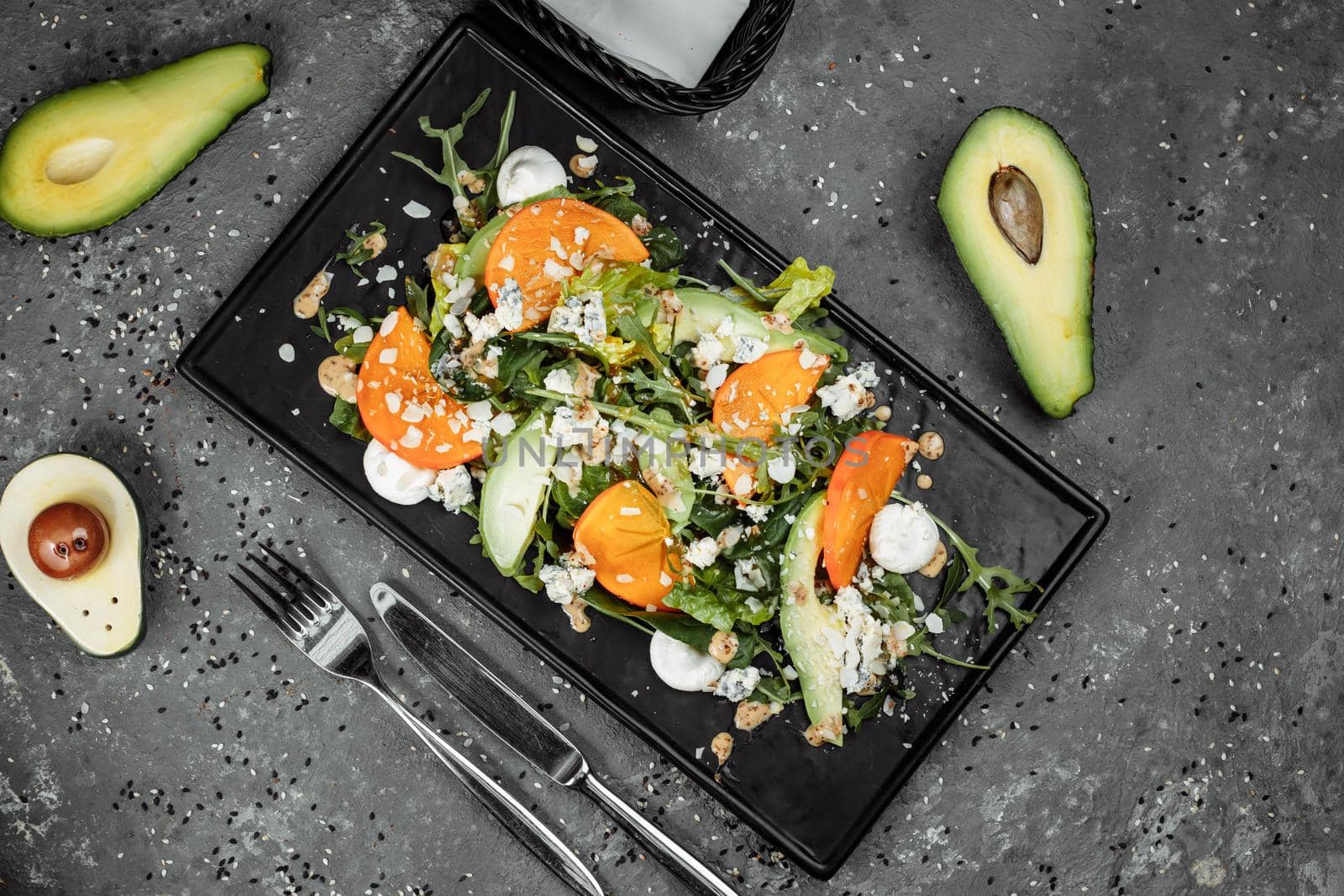 Fresh salad with fruits and greens on dark canvas background. Healthy food by UcheaD