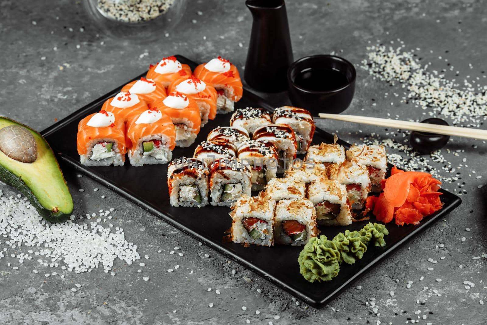 Sushi set with fresh ingredients on gray background. Sushi menu. Japanese food.