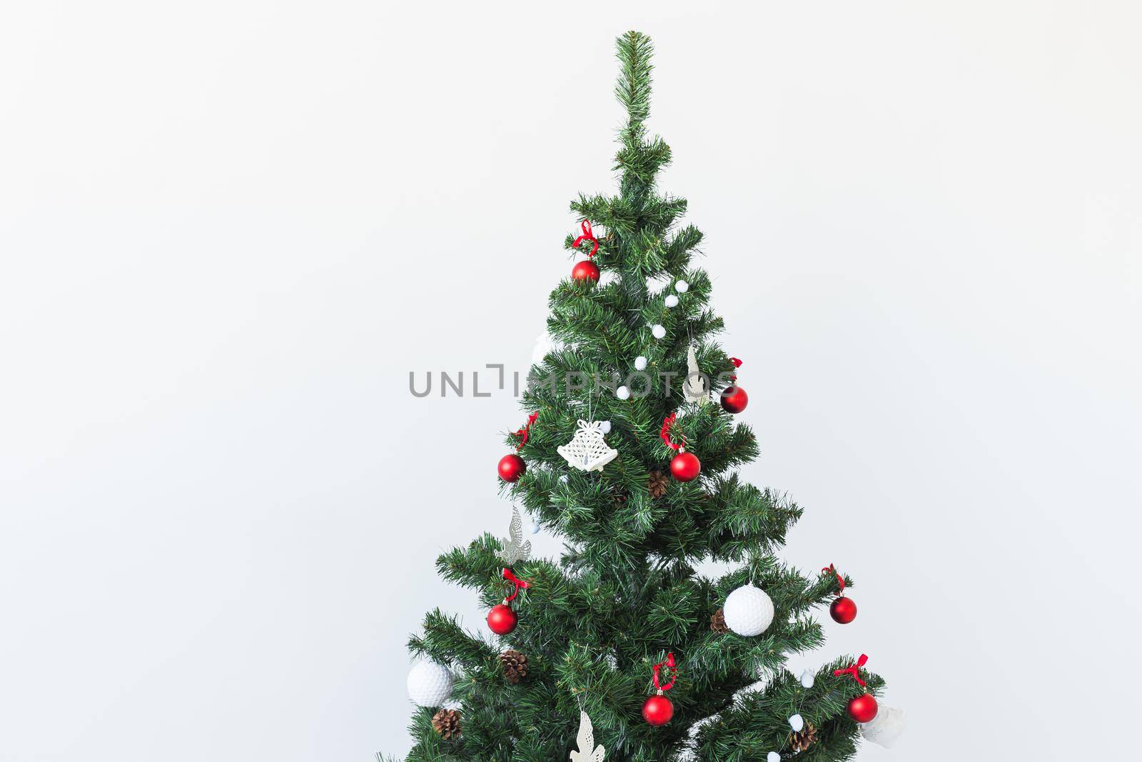 Holidays and celebration concept - Decorated Christmas tree on white background with copy space. by Satura86