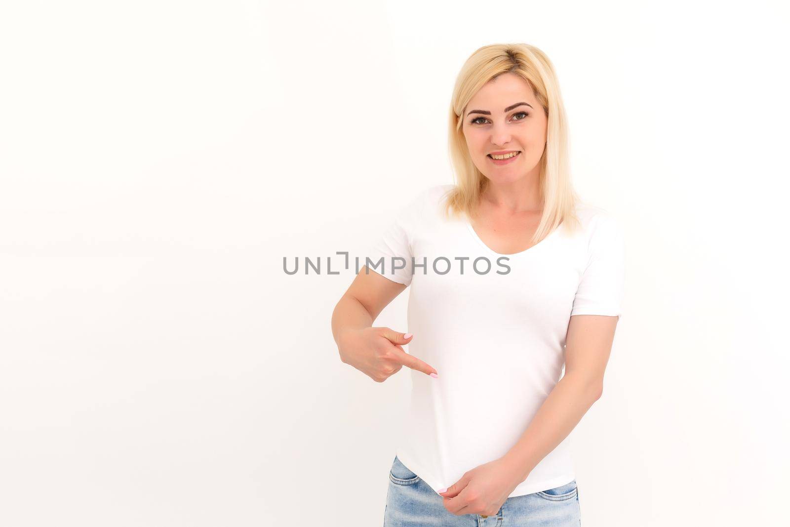 woman shows a spot on her white t-shirt