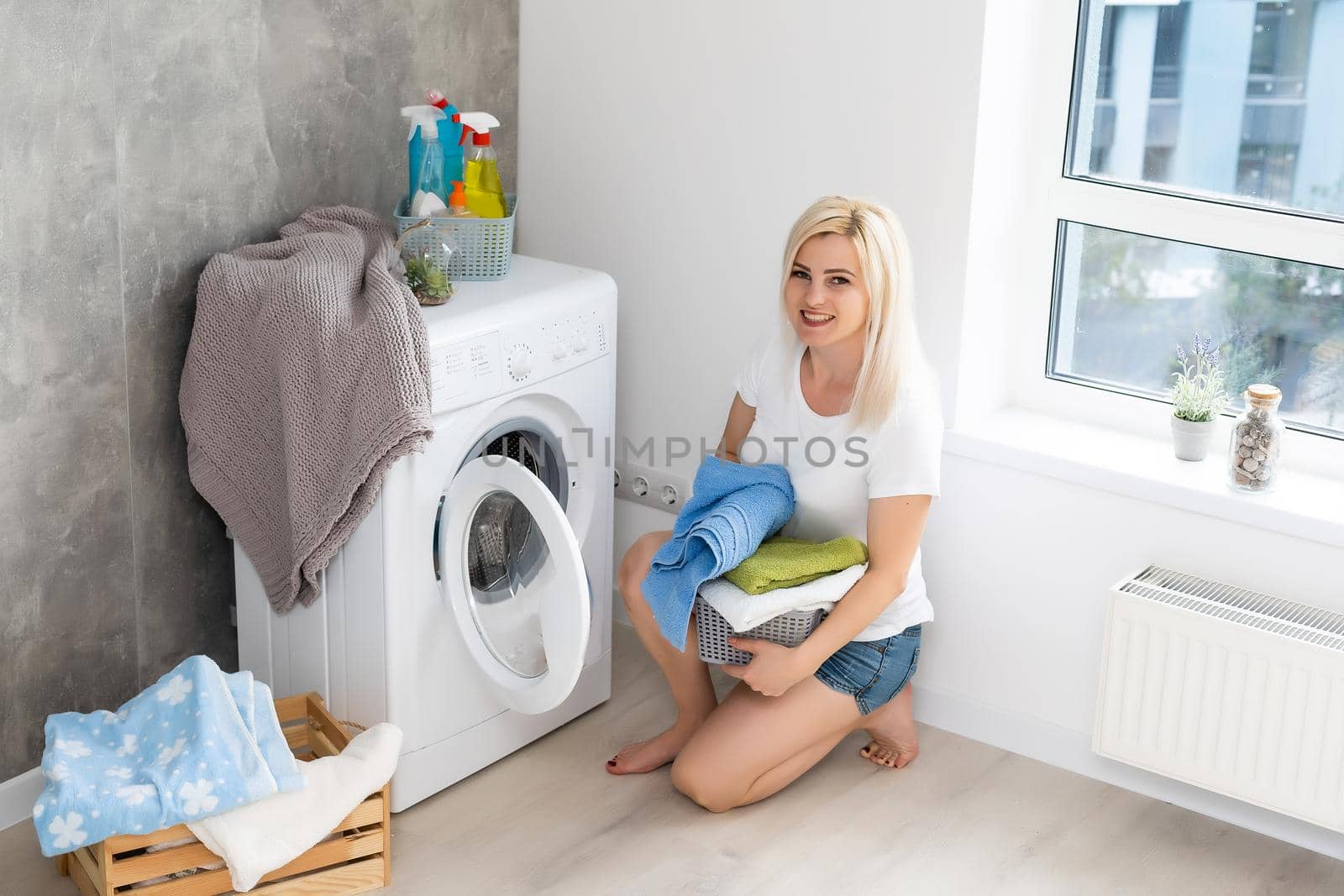 Housework, young woman doing laundry