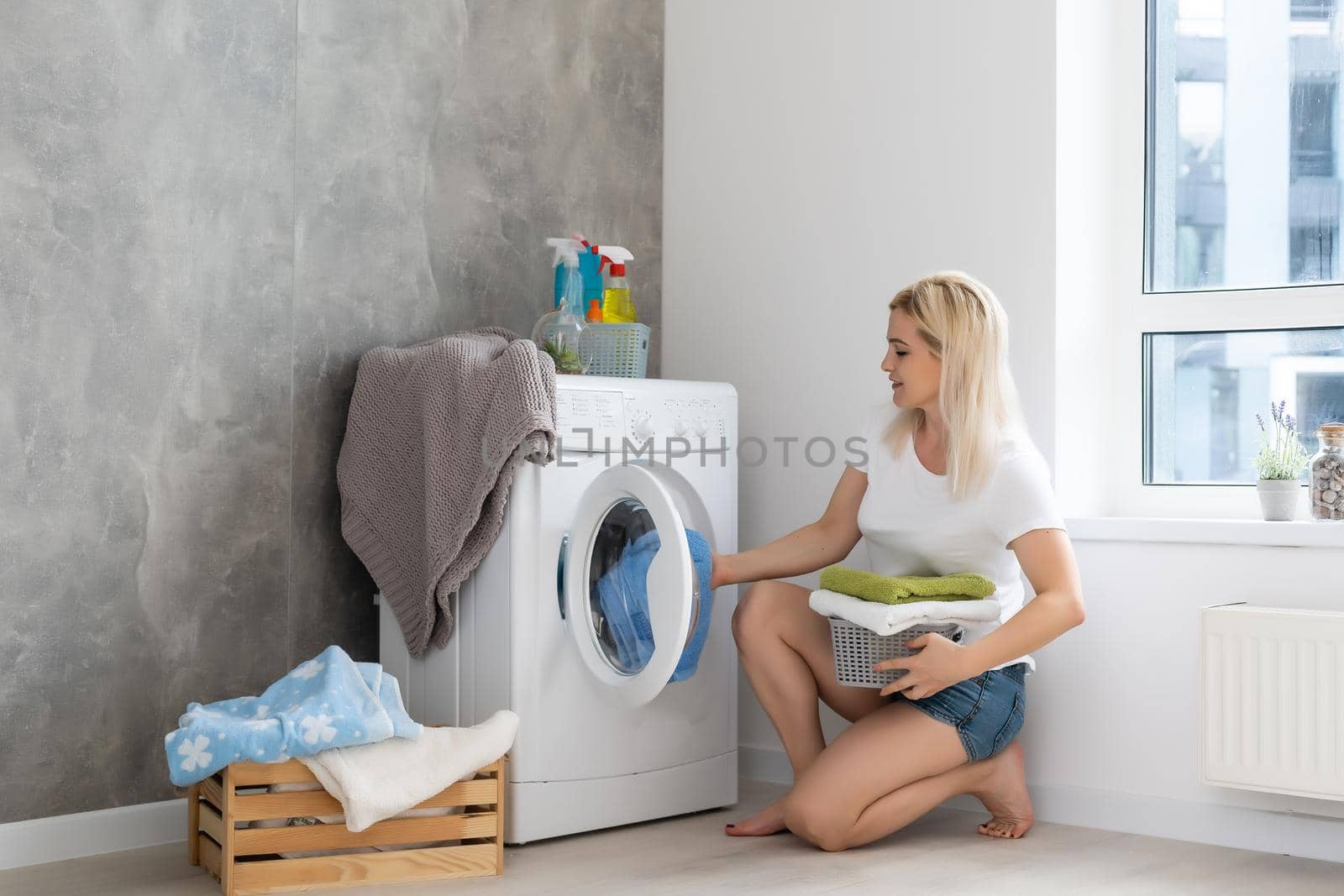 Housework, young woman doing laundry