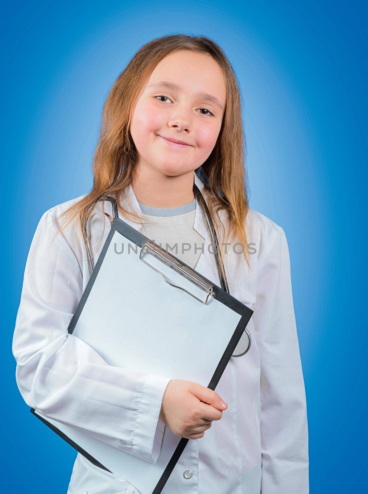 Little girl in medical uniform holds clipboard, space for text