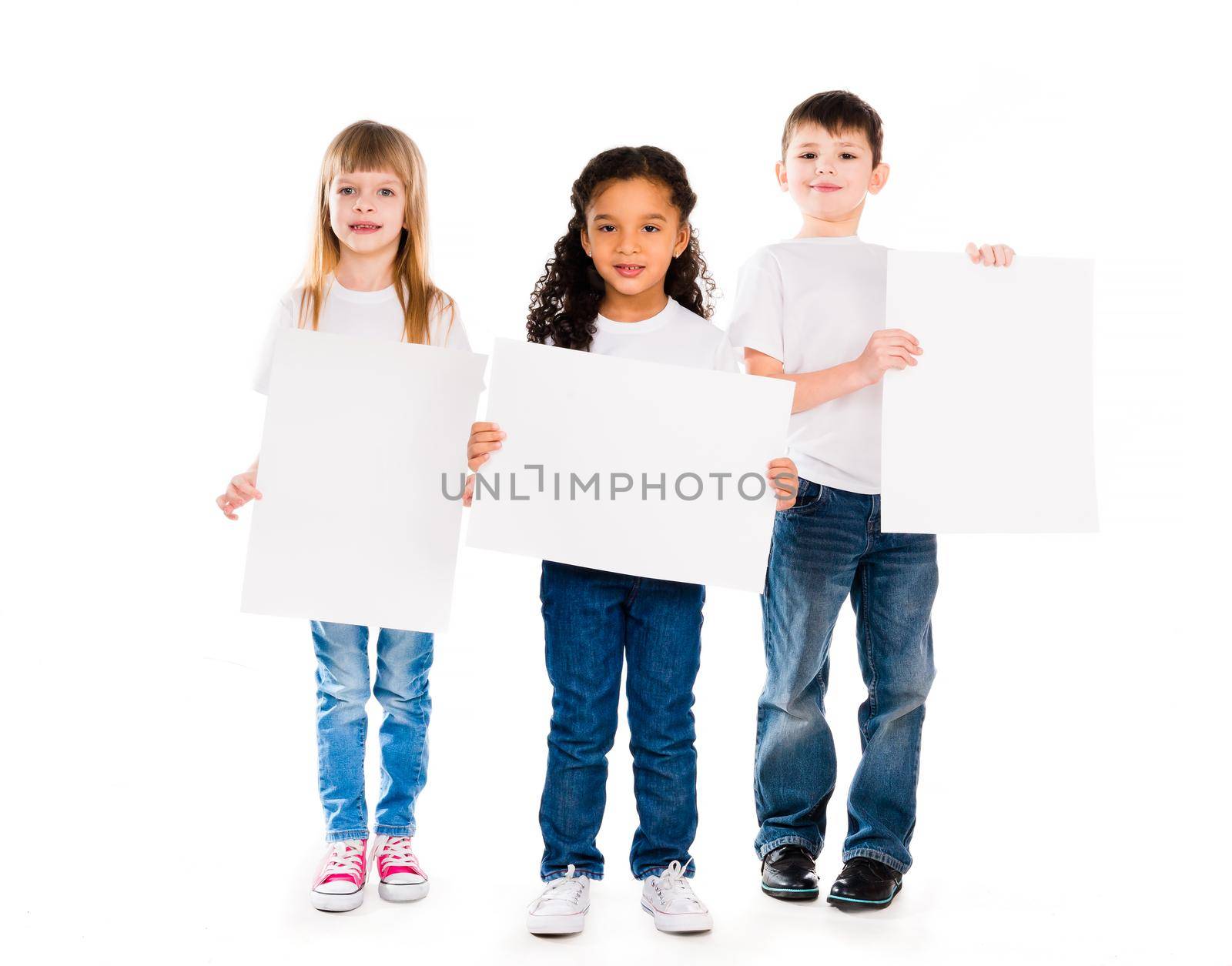 three funny children holding paper blanks in hands isolated on white background