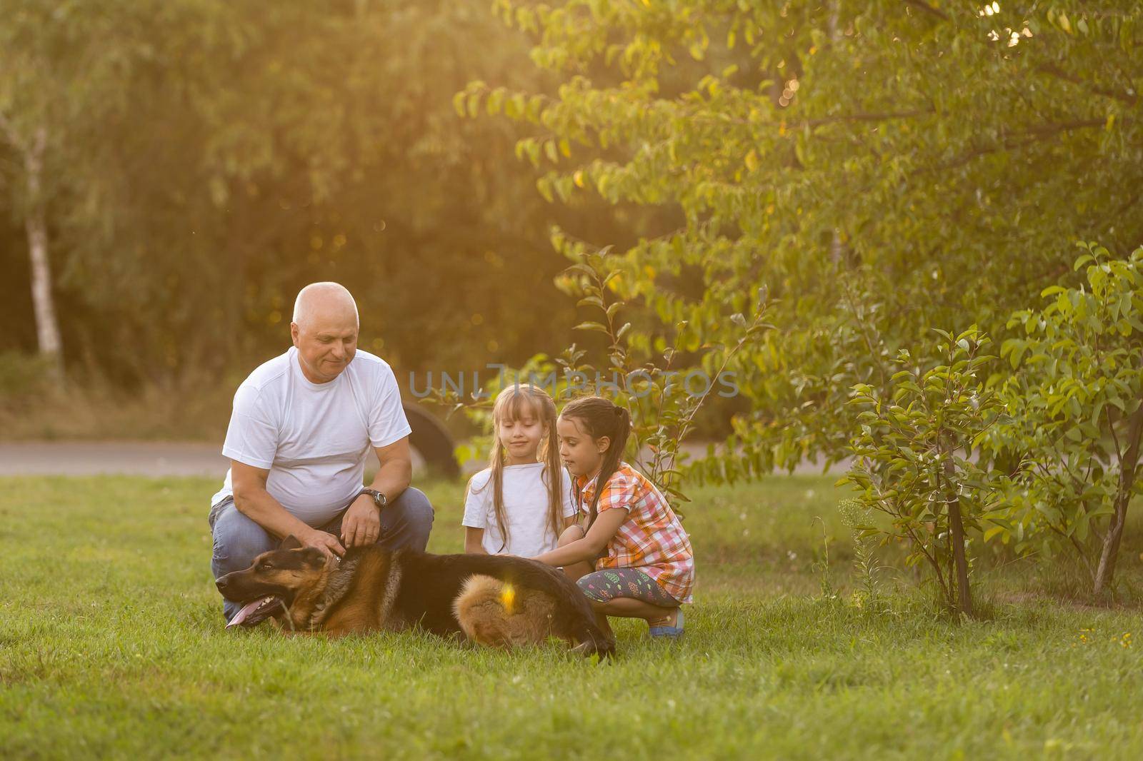 Grandfather And Granddaughters Taking Dog For Walk by Andelov13