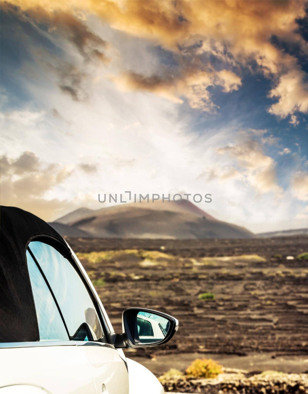 car on offroad by mountain at sunset